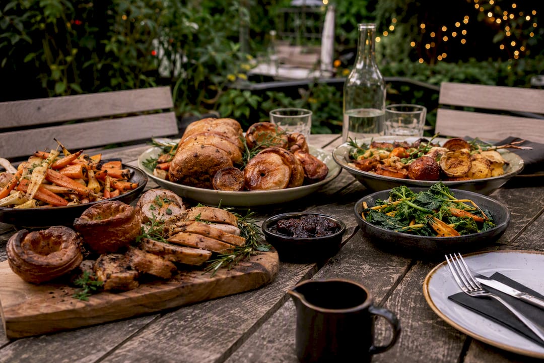 Vegan Sunday carvery meal on wooden table