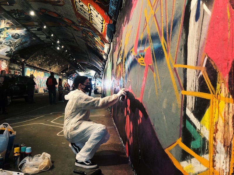 Colourful graffiti murals covering the walls of an underground London tunnel