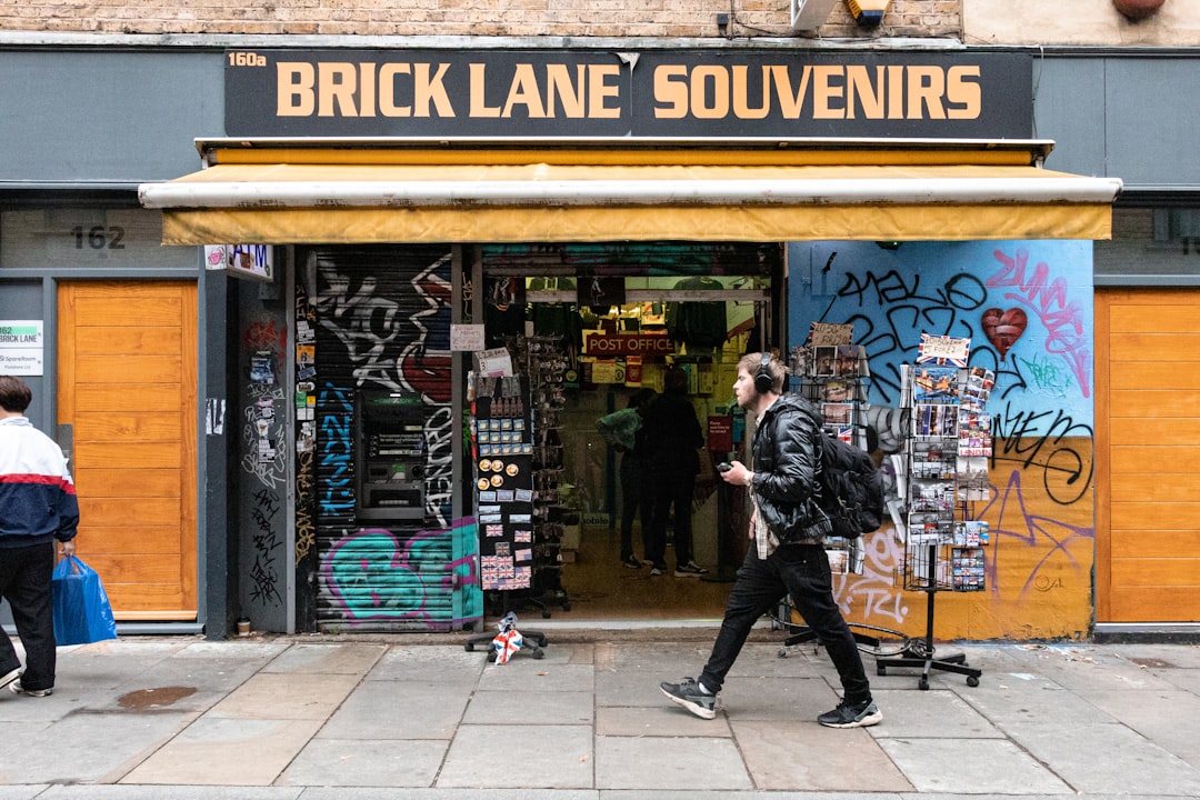 People walking past shops on Brick Lane, East London