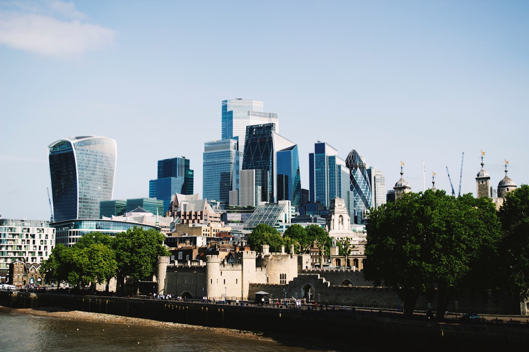 Modern skyscrapers behind historic London buildings along the Thames