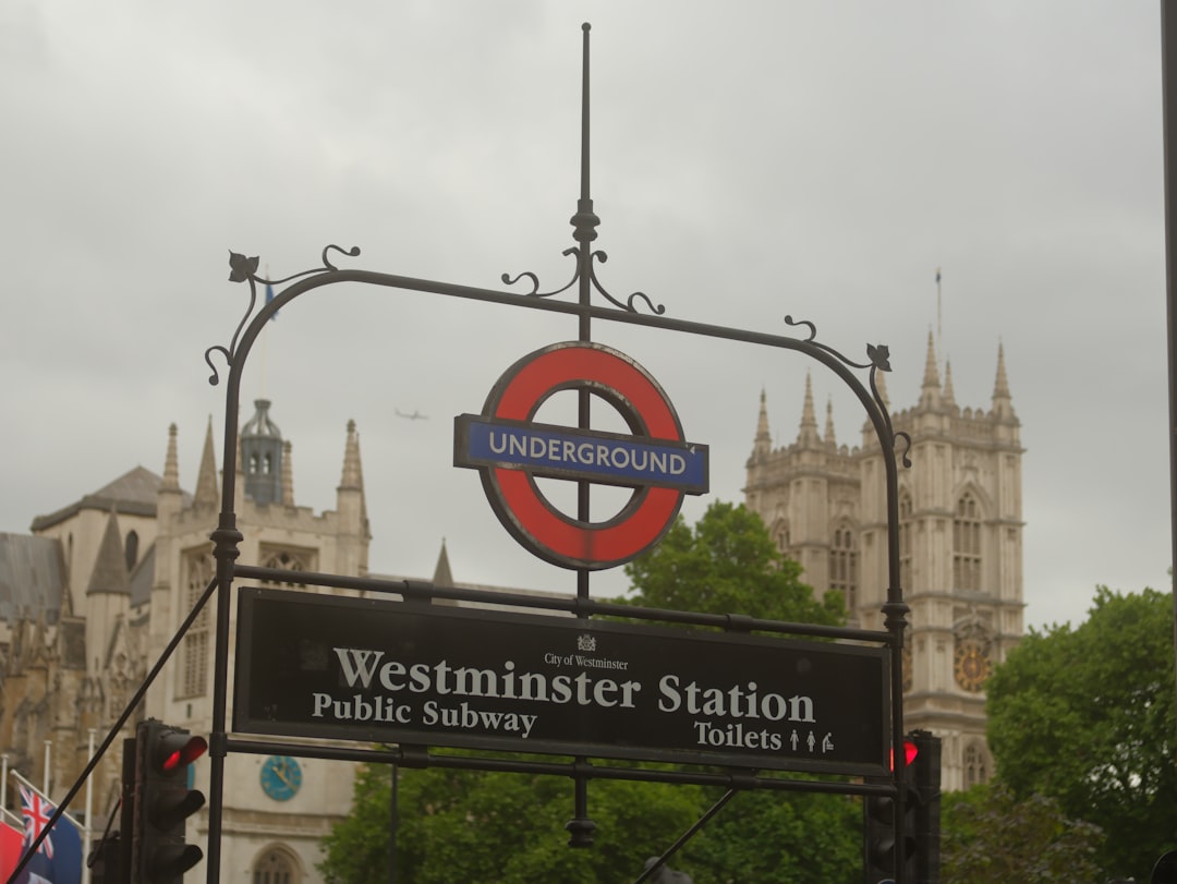 Westminster Underground station sign with Big Ben visible behind, London